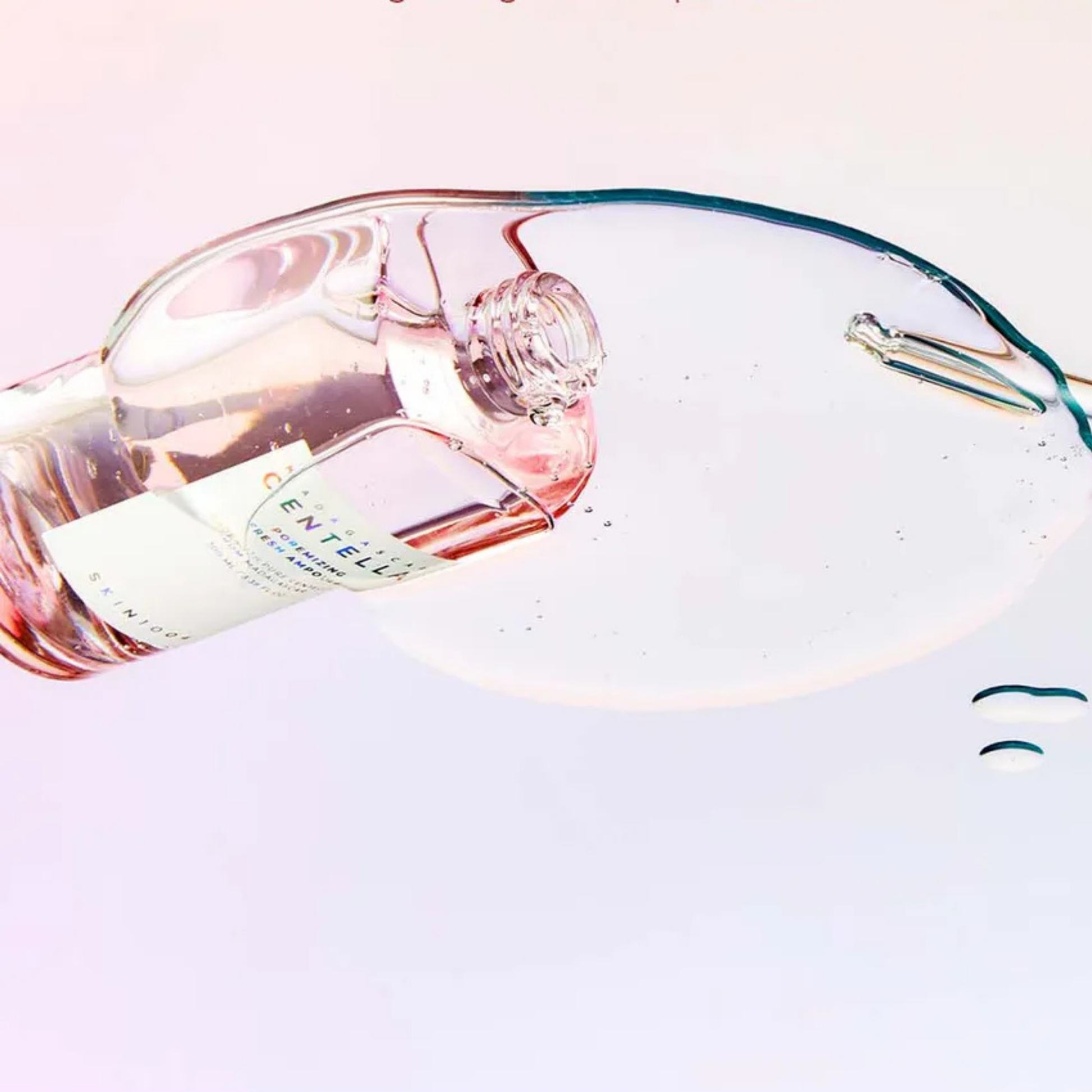 Bottle of SKIN1004 Madagascar Centella Poremizing Fresh Ampoule tipped over with the serum on a glass top