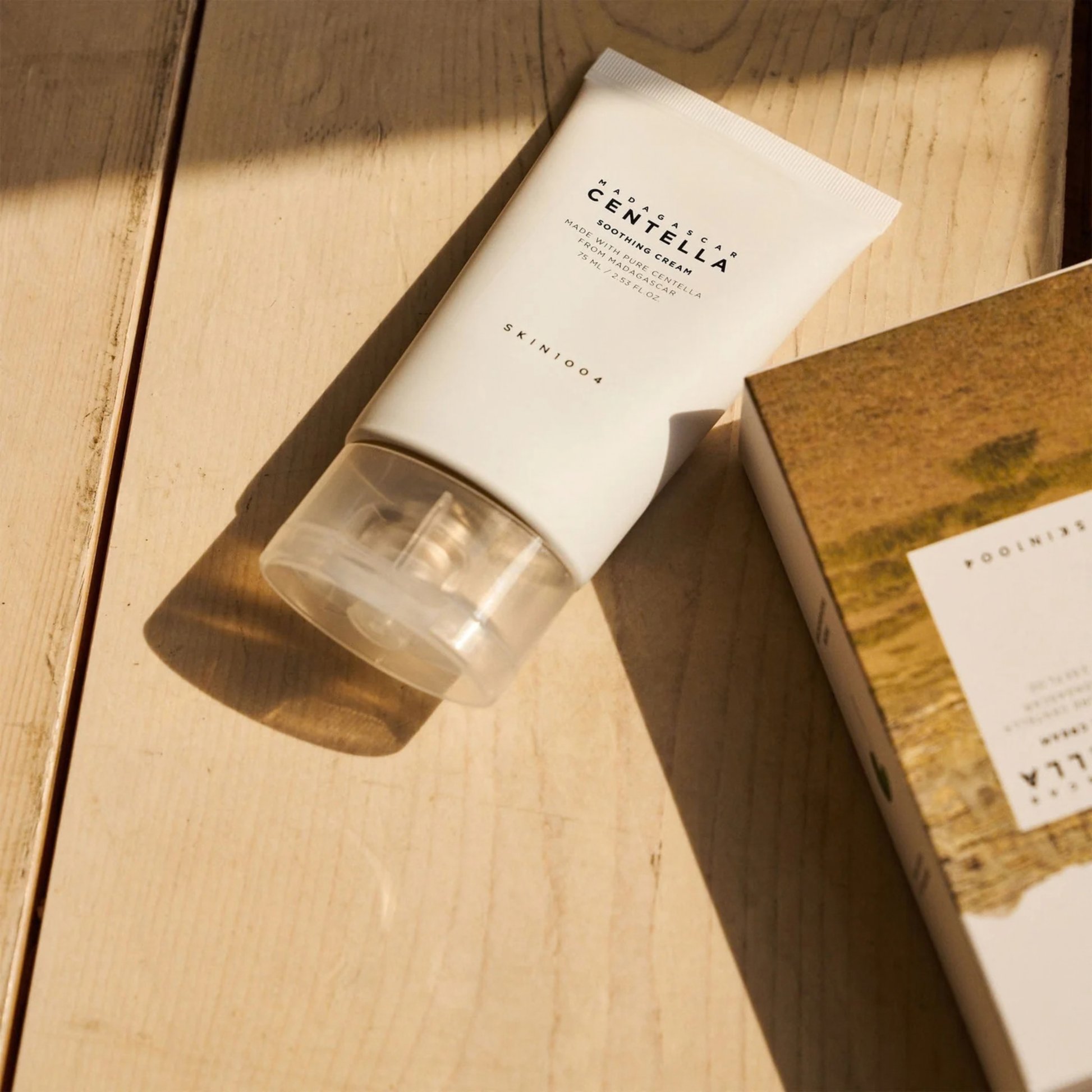 SKIN1004 Madagascar Centella Soothing Cream on a wooden surface