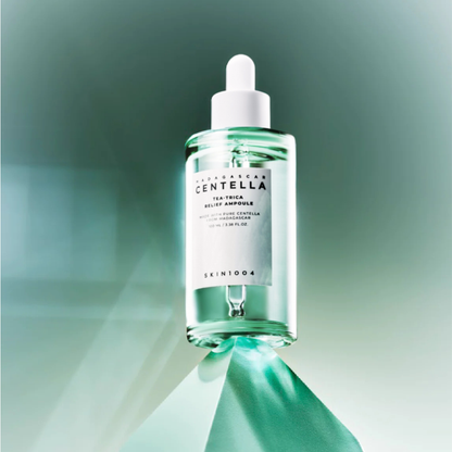 SKIN1004 Madagascar Centella Tea-Trica Relief Ampoule bottle on a green triangle with a green background