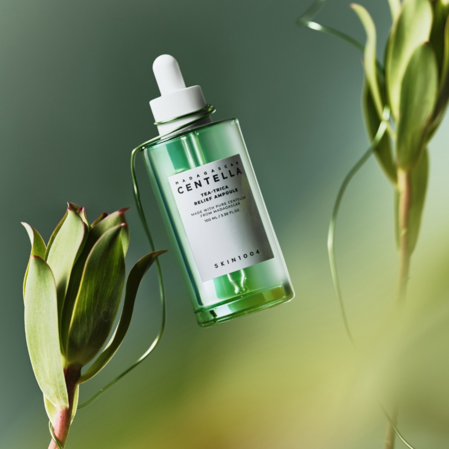 SKIN1004 Madagascar Centella Tea-Trica Relief Ampoule bottle held up with a plant vine