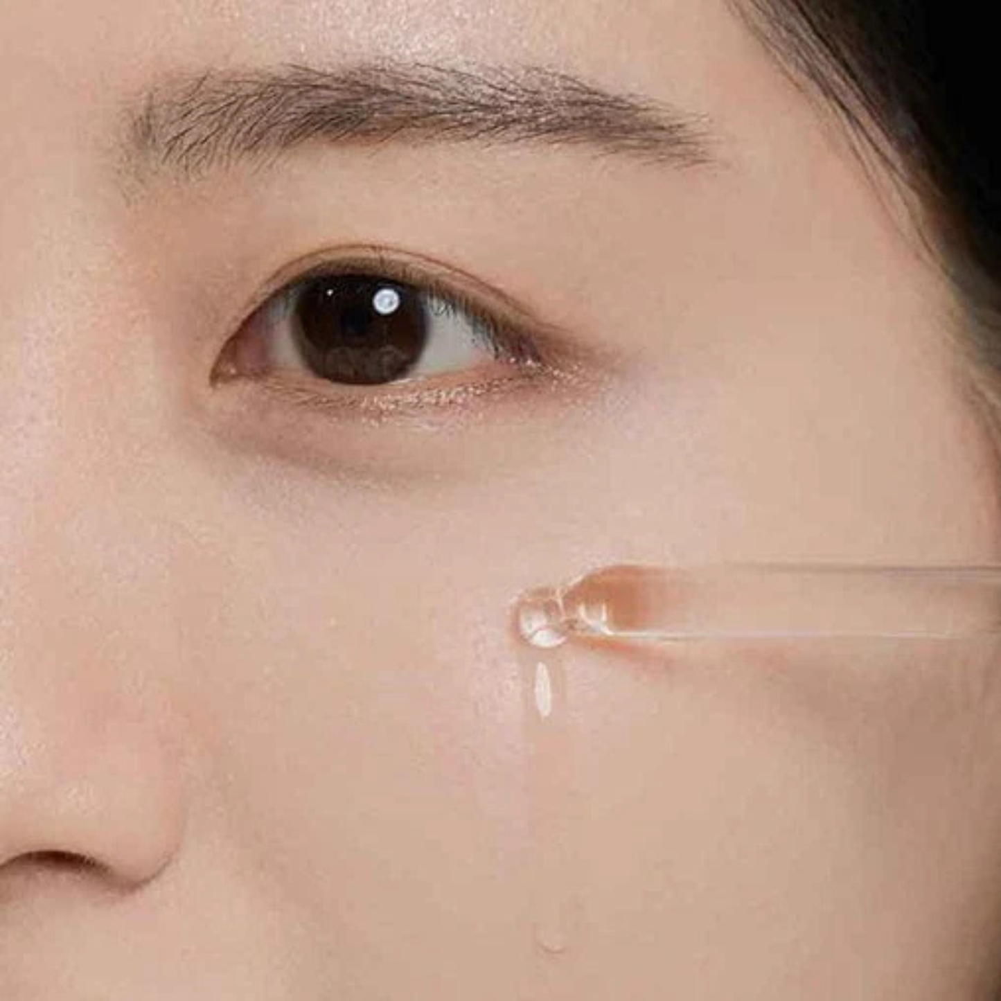 Woman applying SKIN1004 Madagascar Centella Tea-Trica Relief Ampoule to her cheek