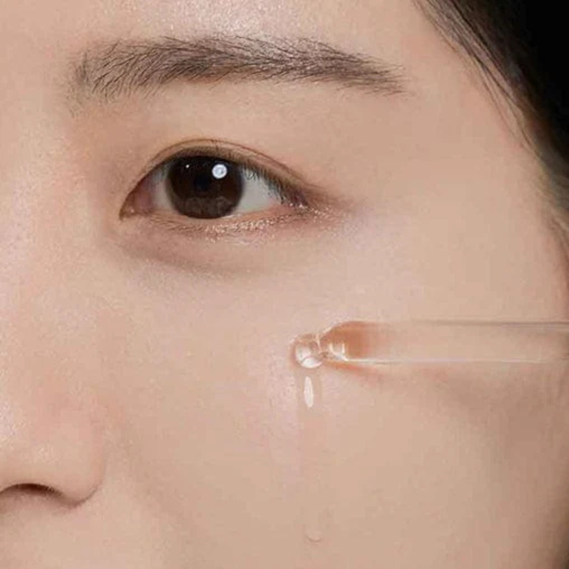 Woman applying SKIN1004 Madagascar Centella Tea-Trica Relief Ampoule to her cheek