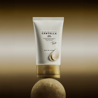 SKIN1004 Madagascar Centella Teca Cream lifestyle shot of tube balancing on a round rock