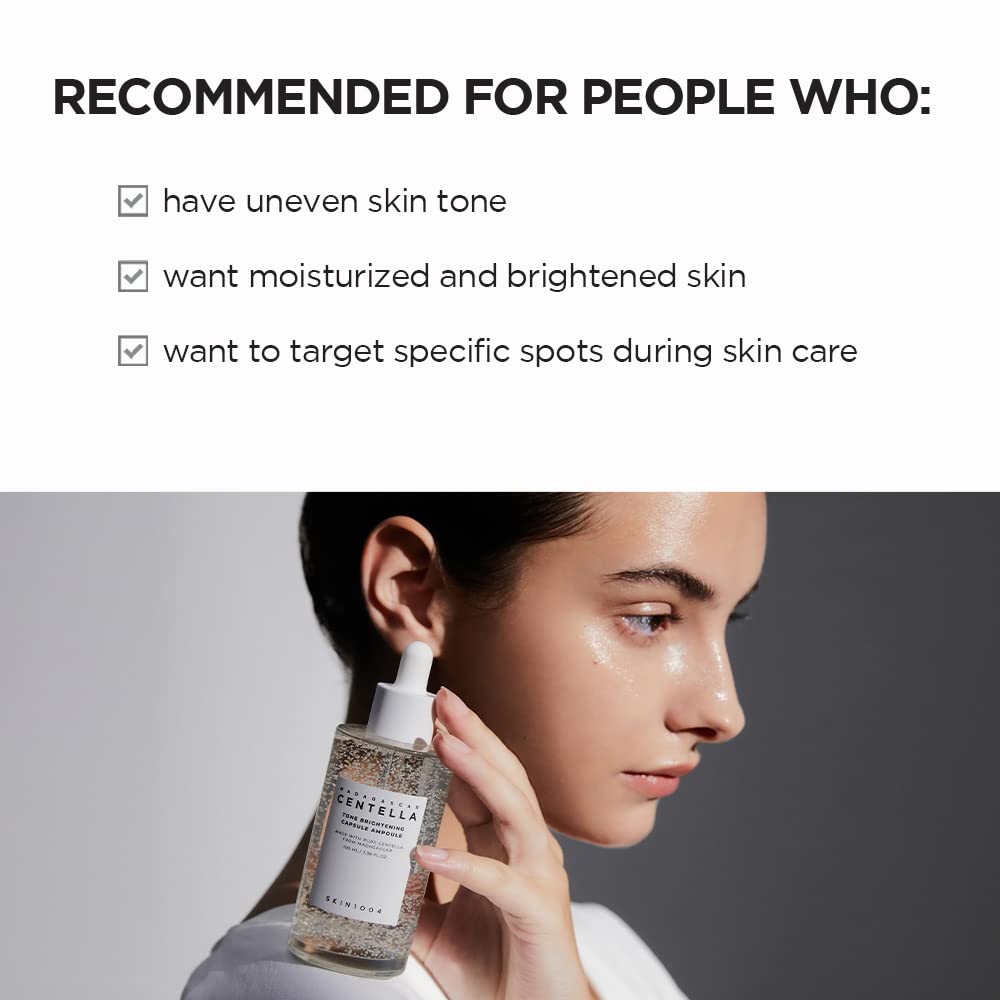 Person holding SKIN1004 Madagascar Centella Tone Brightening Capsule Ampoule with text about recommended skin type on a gray background