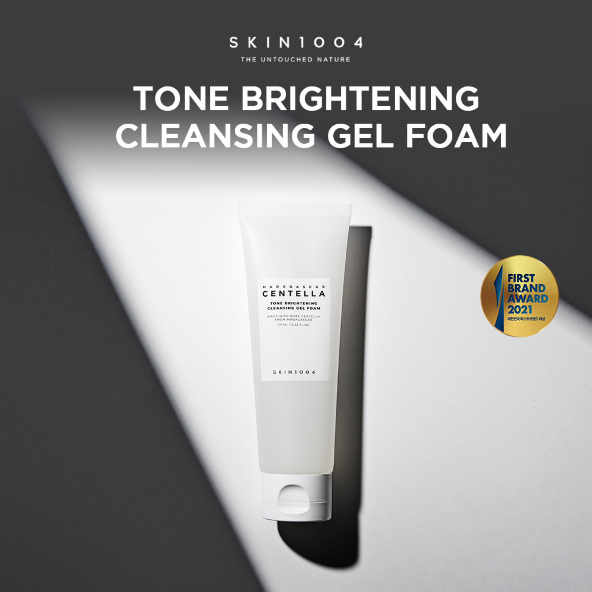 SKIN1004 Madagascar Centella Tone Brightening Cleansing Gel Foam on a dark background with brand name and product description.