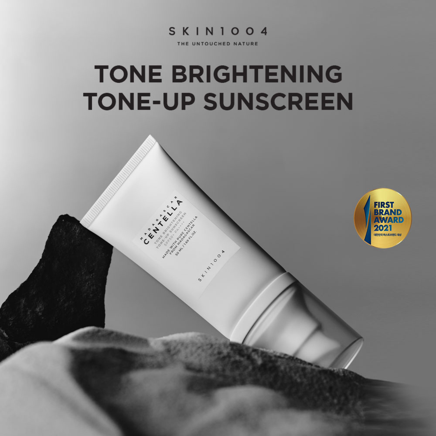 SKIN1004 Madagascar Centella Tone Brightening Tone Up Sunscreen SPF50+ PA++++ on a black and white background