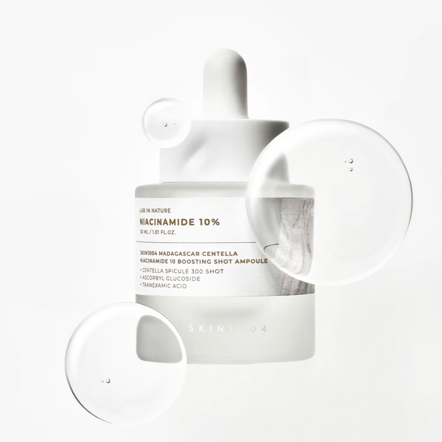 SKIN1004 Niacinamide 10 Boosting Shot Ampoule on white background with serum bubbles