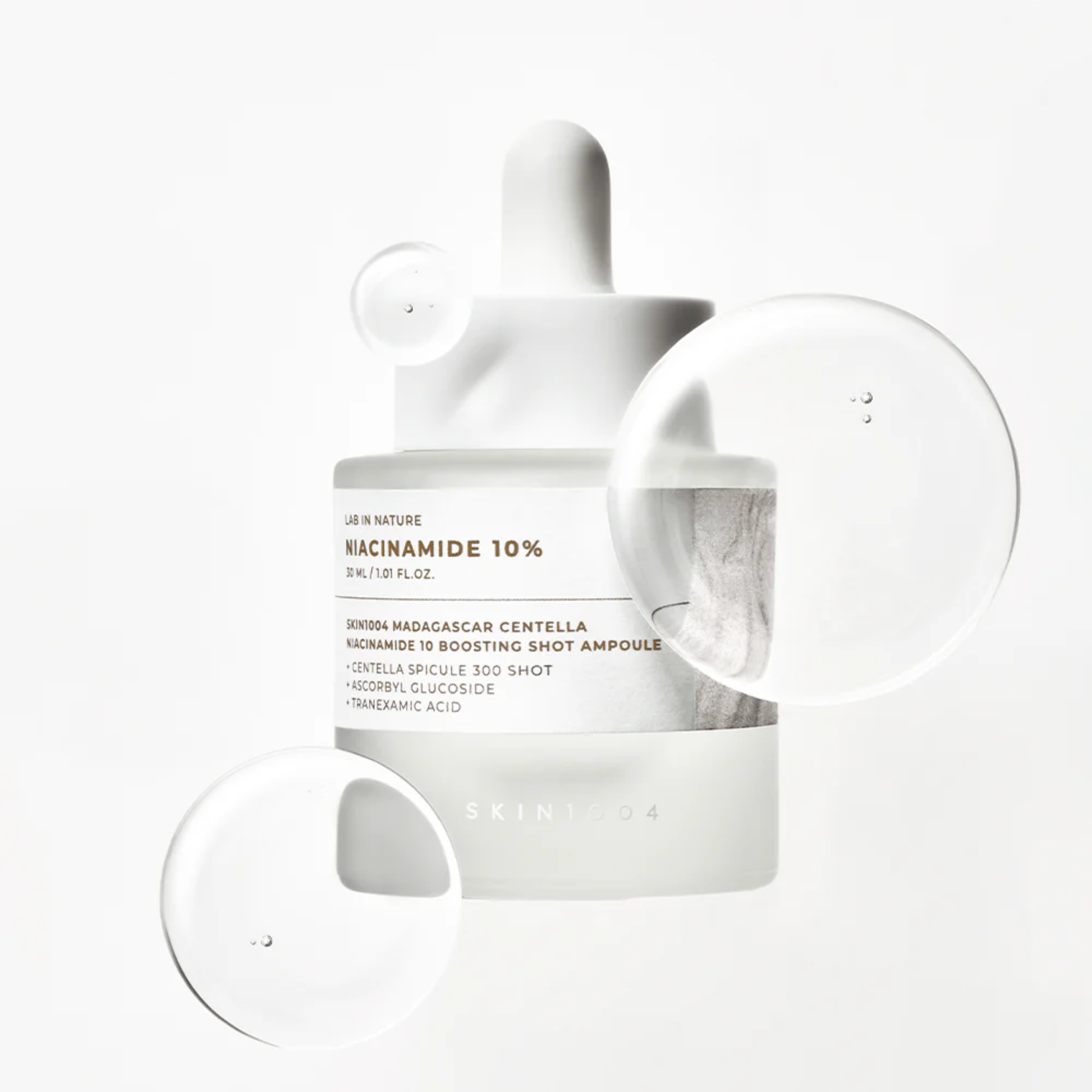 SKIN1004 Niacinamide 10 Boosting Shot Ampoule on white background with serum bubbles