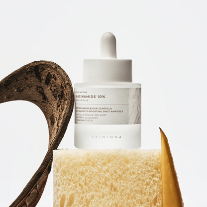 SKIN1004 Niacinamide 10 Boosting Shot Ampoule styled image on a sponge with a white background