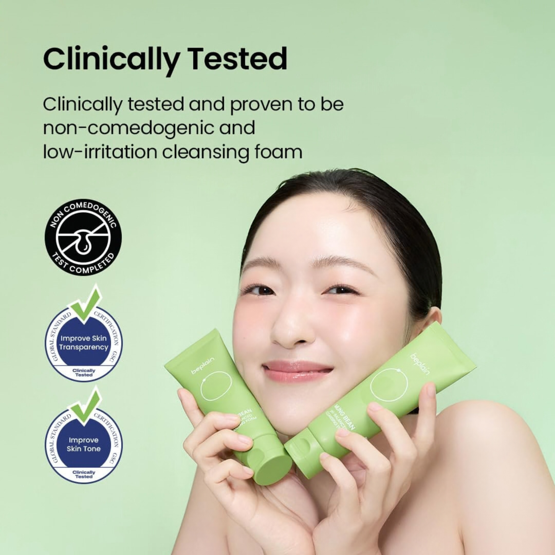 Woman holding two tubes of beplain Mung Bean pH-Balanced Cleansing Foam with text about its clinical testing on a light green background