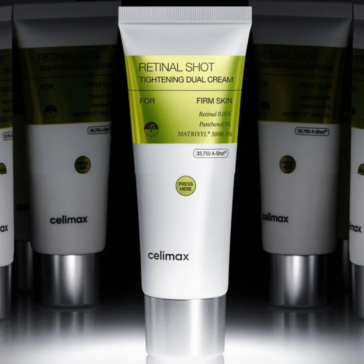 A white tube of Celimax Retinal Shot Tightening Dual Cream is centered, flanked by two partially visible identical tubes on a dark reflective studio background.